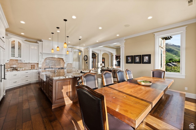 1515 E Maple St, Mapleton, UT 84664 - dining space with ornate columns, dark wood-style flooring, arched walkways, crown molding, and recessed lighting