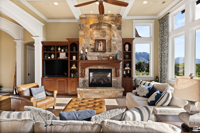 1515 E Maple St, Mapleton, UT 84664 - living room with decorative columns, ceiling fan, beamed ceiling, a fireplace, and crown molding