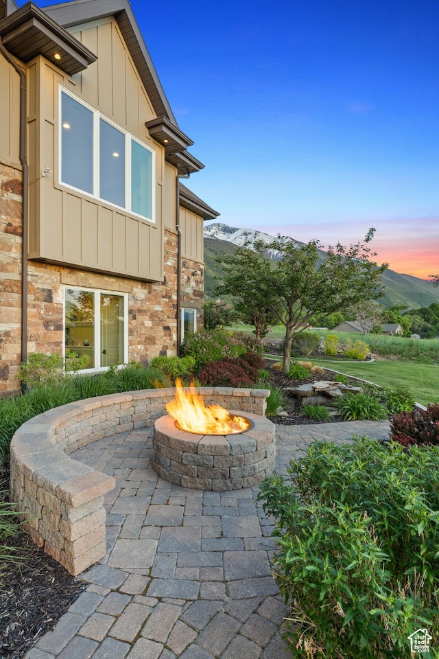 1515 E Maple St, Mapleton, UT 84664 - patio terrace at dusk featuring a fire pit and a mountain view