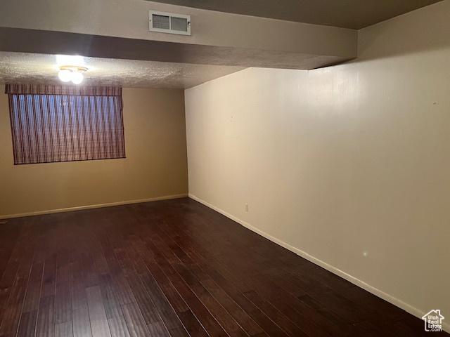 finished basement with dark wood-style floors and baseboards