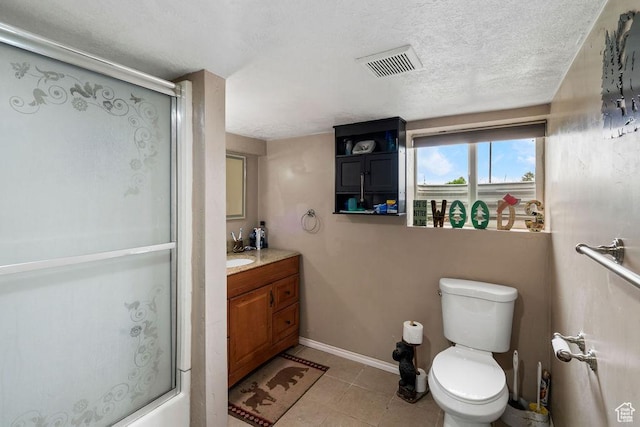 bathroom with an enclosed shower, toilet, baseboards, vanity, and tile patterned floors