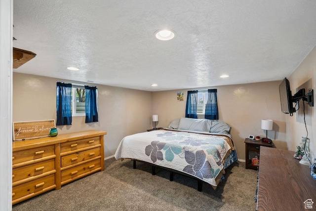 carpeted bedroom featuring baseboards, recessed lighting, and a textured ceiling