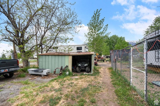 view of yard with fence and an outdoor structure