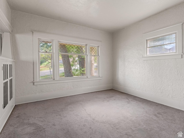 551 E 27th St, Ogden, UT 84403 - carpeted empty room with plenty of natural light, a textured wall, and baseboards