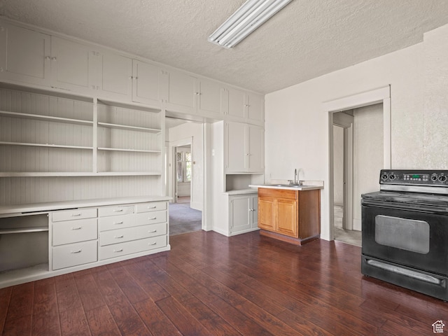 551 E 27th St, Ogden, UT 84403 - kitchen with black range with electric cooktop, dark wood-style flooring, a textured ceiling, light countertops, and open shelves