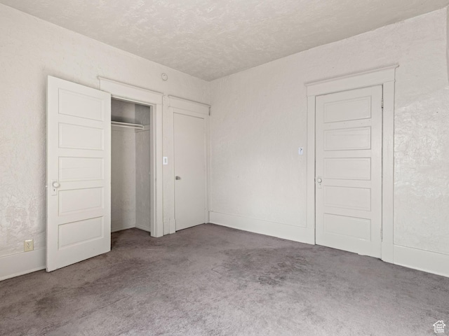 551 E 27th St, Ogden, UT 84403 - unfurnished bedroom featuring carpet flooring, a textured ceiling, and a closet