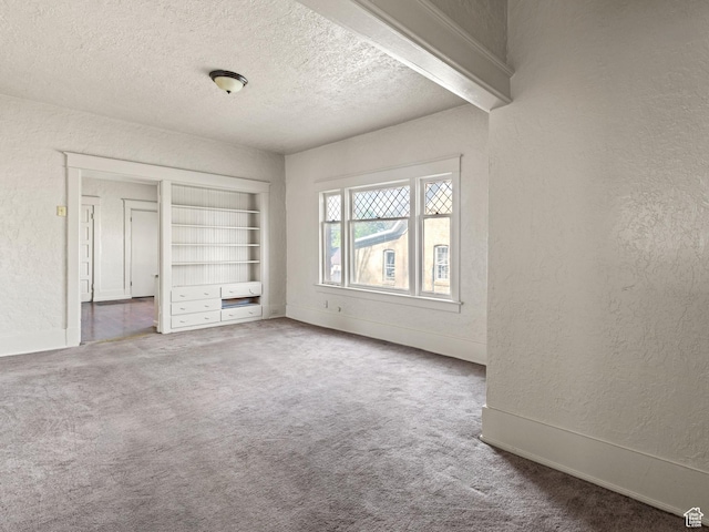 551 E 27th St, Ogden, UT 84403 - unfurnished bedroom with a textured wall, carpet floors, a textured ceiling, and baseboards