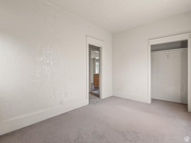 551 E 27th St, Ogden, UT 84403 - unfurnished bedroom with carpet, a closet, a textured ceiling, and baseboards