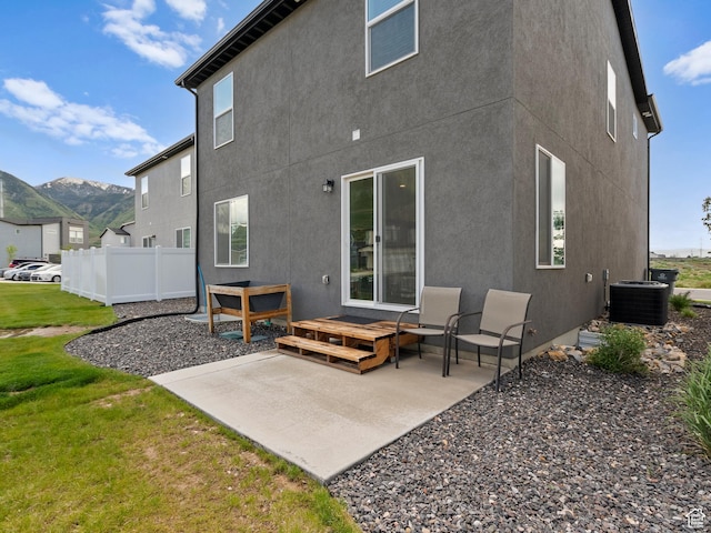3957 S White Ash Dr, Mapleton, UT 84664 - rear view of house with a patio area, stucco siding, cooling unit, and a mountain view