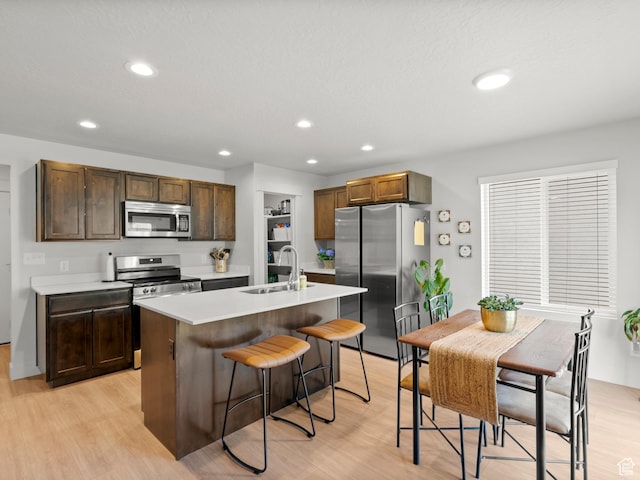 3957 S White Ash Dr, Mapleton, UT 84664 - kitchen featuring appliances with stainless steel finishes, a sink, light wood finished floors, and recessed lighting