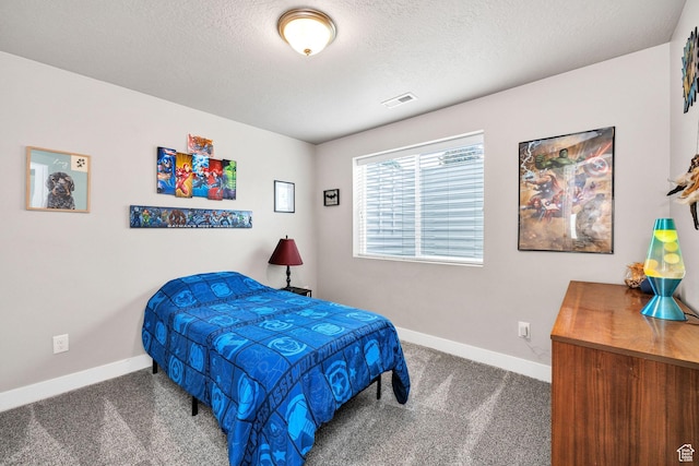 bedroom with baseboards, carpet flooring, and a textured ceiling