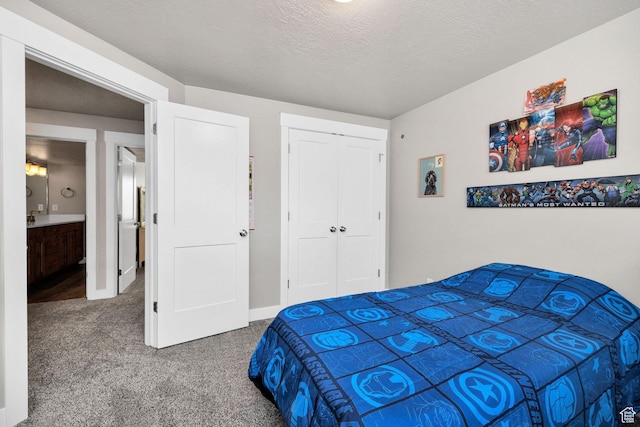 bedroom with carpet floors, a closet, a textured ceiling, and baseboards