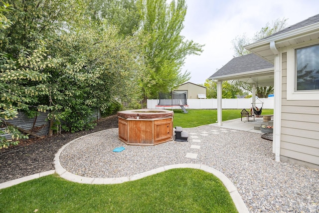 view of yard featuring a trampoline and a patio area