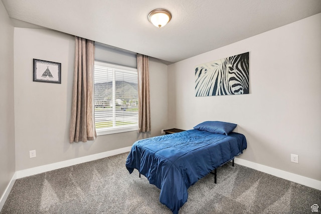 bedroom featuring carpet and baseboards