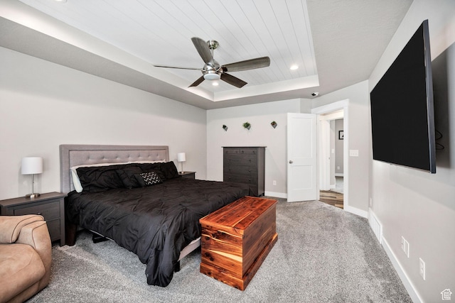 bedroom with carpet, baseboards, a tray ceiling, ceiling fan, and recessed lighting