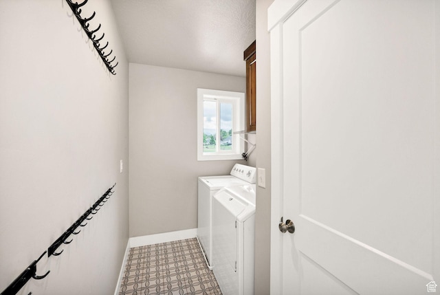 washroom with washer and dryer, cabinet space, baseboards, and tile patterned floors