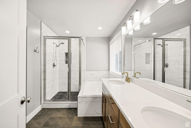 full bathroom featuring a stall shower, recessed lighting, a garden tub, and double vanity