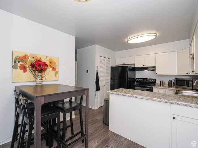 kitchen featuring black appliances, exhaust hood, a peninsula, white cabinets, and dark wood-style flooring