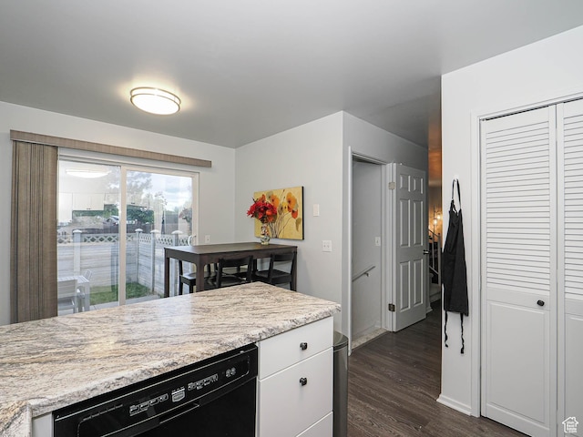 kitchen featuring black dishwasher, dark wood-style flooring, light countertops, and white cabinets