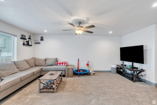 carpeted living area with a ceiling fan, a textured ceiling, recessed lighting, and baseboards