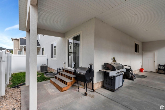 view of patio featuring entry steps, grilling area, fence, and central AC unit