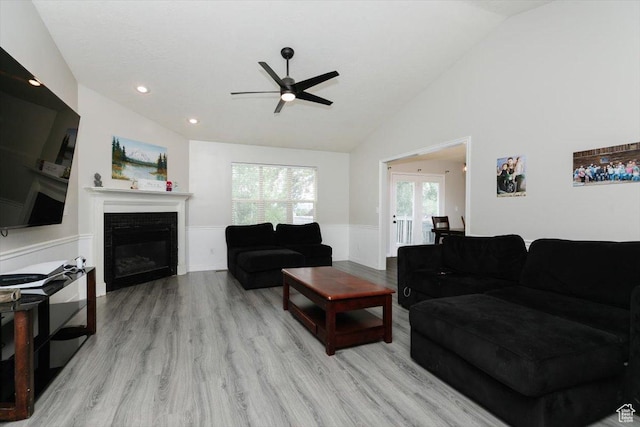 375 S 900 E, Smithfield, UT 84335 - living room featuring vaulted ceiling, ceiling fan, a wainscoted wall, light wood-style floors, and a glass covered fireplace