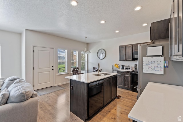 715 N 2560 E, Spanish Fork, UT 84660 - kitchen featuring a sink, black appliances, open floor plan, dark brown cabinetry, and light countertops