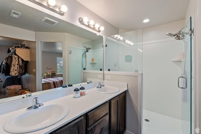 715 N 2560 E, Spanish Fork, UT 84660 - ensuite bathroom featuring a shower stall, a textured ceiling, and double vanity