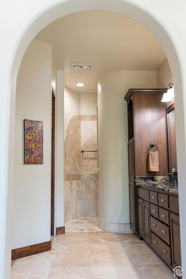 2090 N Tuweap Dr Unit 15, St George, UT 84770 - bathroom with baseboards, double vanity, tiled shower, and recessed lighting