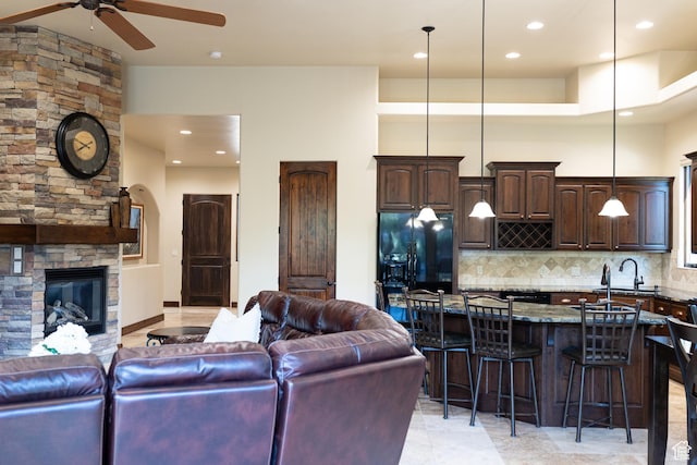 2090 N Tuweap Dr Unit 15, St George, UT 84770 - living area with ceiling fan, a stone fireplace, recessed lighting, and arched walkways