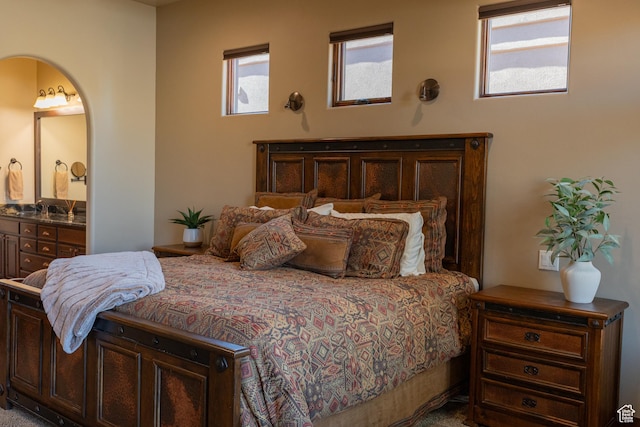 2090 N Tuweap Dr Unit 15, St George, UT 84770 - bedroom with ensuite bathroom, arched walkways, and a sink