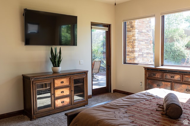 2090 N Tuweap Dr Unit 15, St George, UT 84770 - bedroom featuring access to exterior, carpet floors, and baseboards