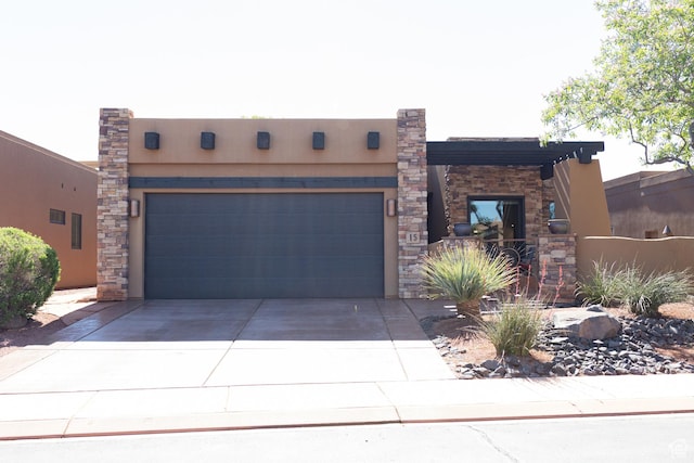 2090 N Tuweap Dr Unit 15, St George, UT 84770 - pueblo-style home with concrete driveway, a garage, and stucco siding
