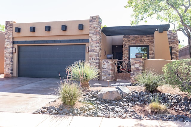 2090 N Tuweap Dr Unit 15, St George, UT 84770 - view of front of house featuring concrete driveway, an attached garage, and stucco siding
