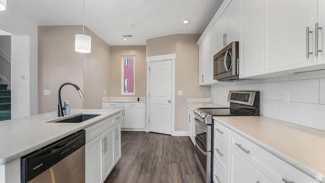 4955 W Daybreak Pkwy, South Jordan, UT 84009 - kitchen with appliances with stainless steel finishes, a sink, dark wood-type flooring, light countertops, and backsplash