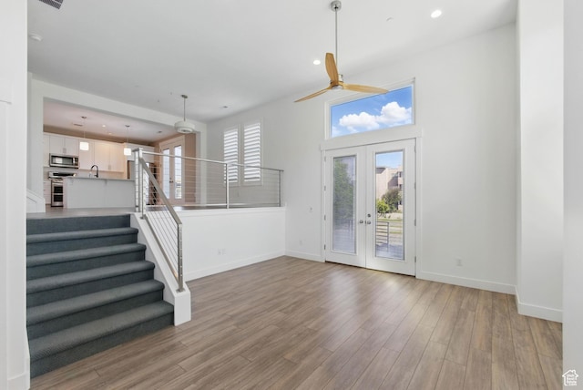 4955 W Daybreak Pkwy, South Jordan, UT 84009 - entryway with baseboards, ceiling fan, wood finished floors, stairway, and recessed lighting
