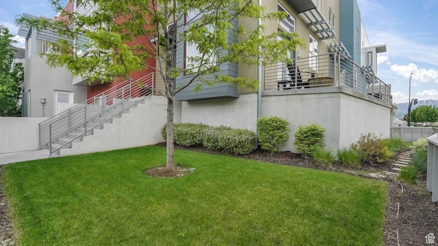 4955 W Daybreak Pkwy, South Jordan, UT 84009 - view of side of home featuring a lawn, stucco siding, and stairs