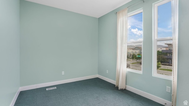 4955 W Daybreak Pkwy, South Jordan, UT 84009 - empty room featuring dark colored carpet and baseboards
