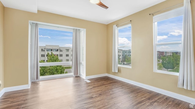 4955 W Daybreak Pkwy, South Jordan, UT 84009 - spare room featuring wood finished floors, plenty of natural light, and baseboards