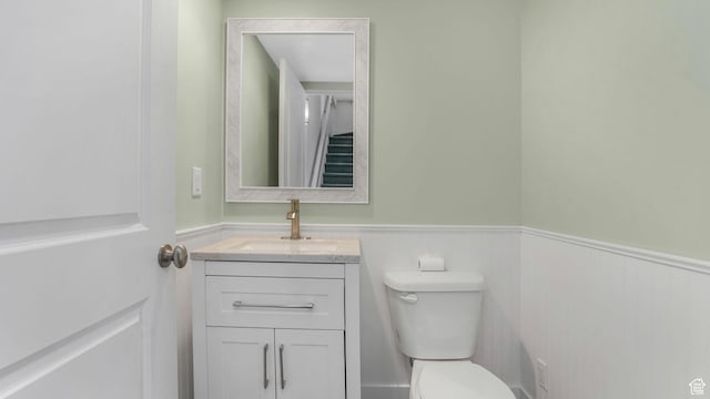 4955 W Daybreak Pkwy, South Jordan, UT 84009 - bathroom featuring toilet, a wainscoted wall, and vanity