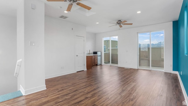 4955 W Daybreak Pkwy, South Jordan, UT 84009 - unfurnished living room with a ceiling fan, dark wood-type flooring, baseboards, and recessed lighting