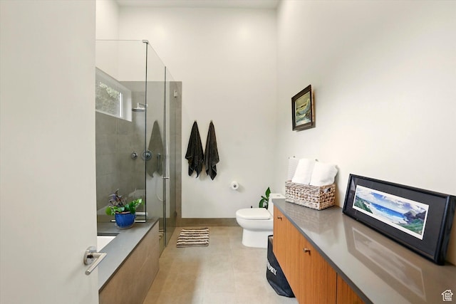 bathroom with a shower stall, toilet, vanity, and tile patterned flooring