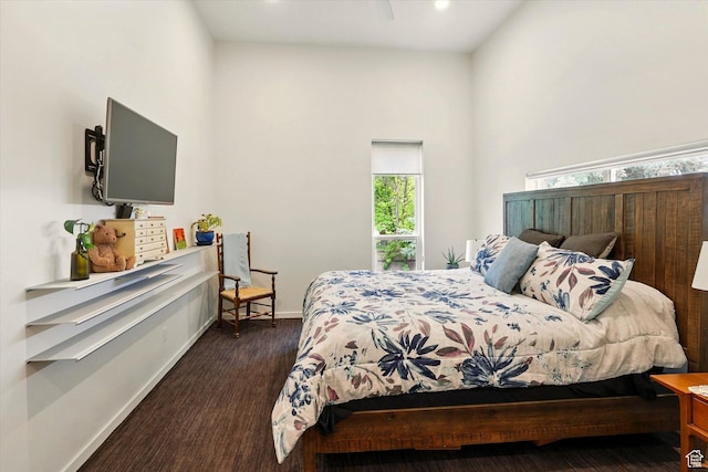 bedroom featuring baseboards, a high ceiling, and recessed lighting