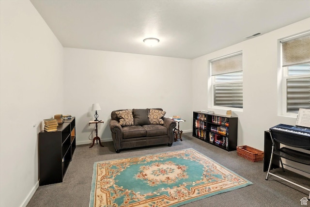 living area featuring carpet floors and baseboards