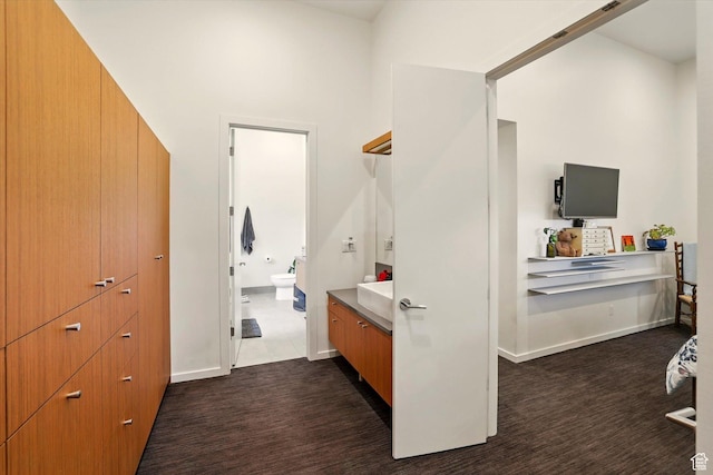 bathroom featuring vanity, toilet, and baseboards