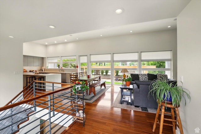 living area with recessed lighting and wood finished floors