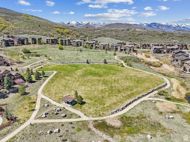 aerial overview of property's location with nearby suburban area and a mountainous background