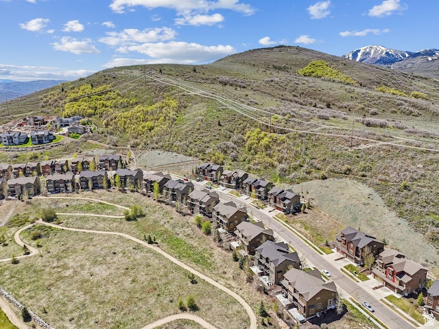 aerial overview of property's location featuring nearby suburban area and a mountain backdrop