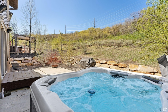 view of swimming pool with a hot tub