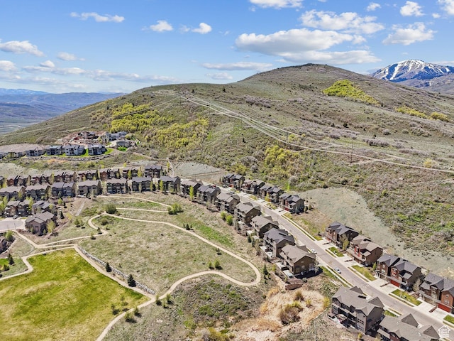 view of property location featuring nearby suburban area and a mountain backdrop